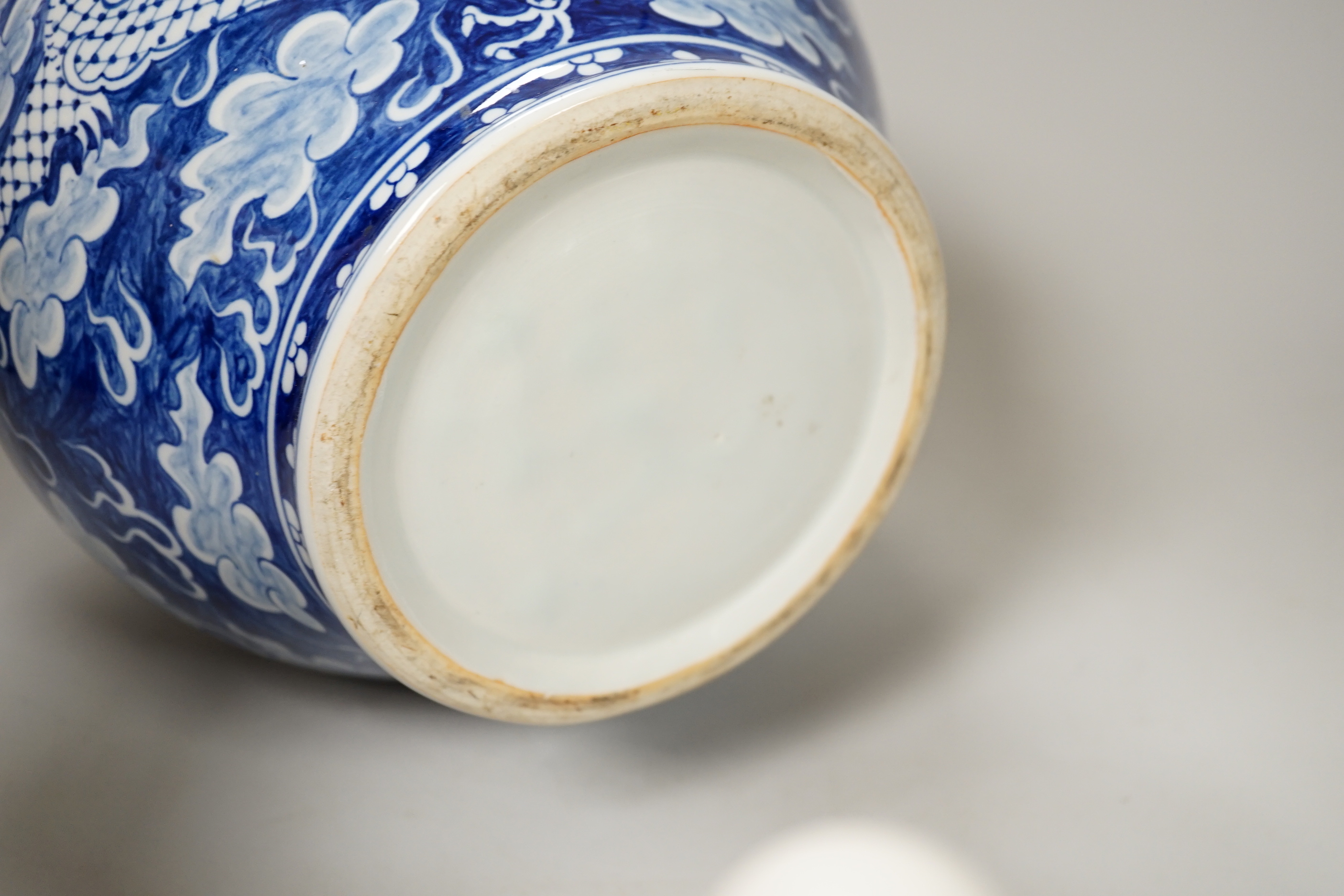 A group of Chinese ceramics including a celadon glazed vase, blue and white jar, white glazed figure and a jardiniere